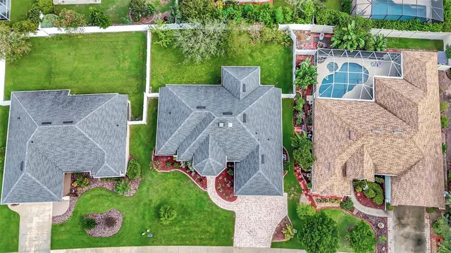 an aerial view of multiple houses with a yard