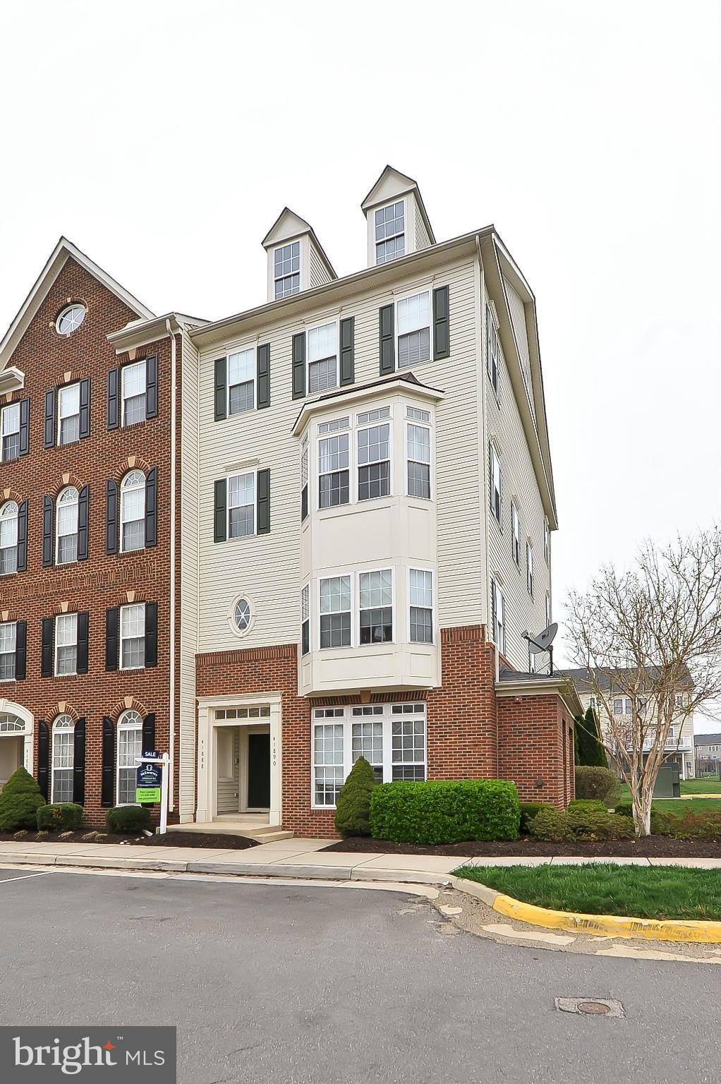 41888 Inspiration Terrace Aldie, VA 20105 - Photo 1 of 30 a front view of a residential apartment building with a yard