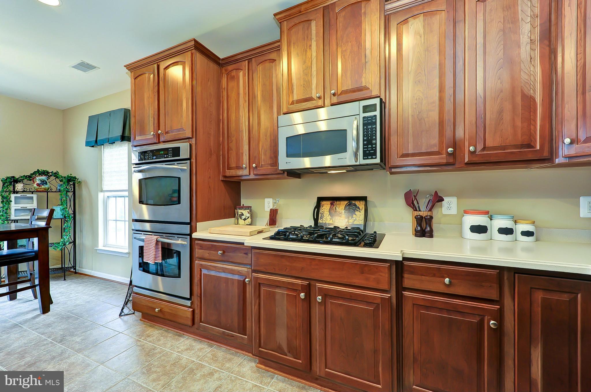 41888 Inspiration Terrace Aldie, VA 20105 - Photo 2 of 30 a kitchen with stainless steel appliances granite countertop a refrigerator and microwave
