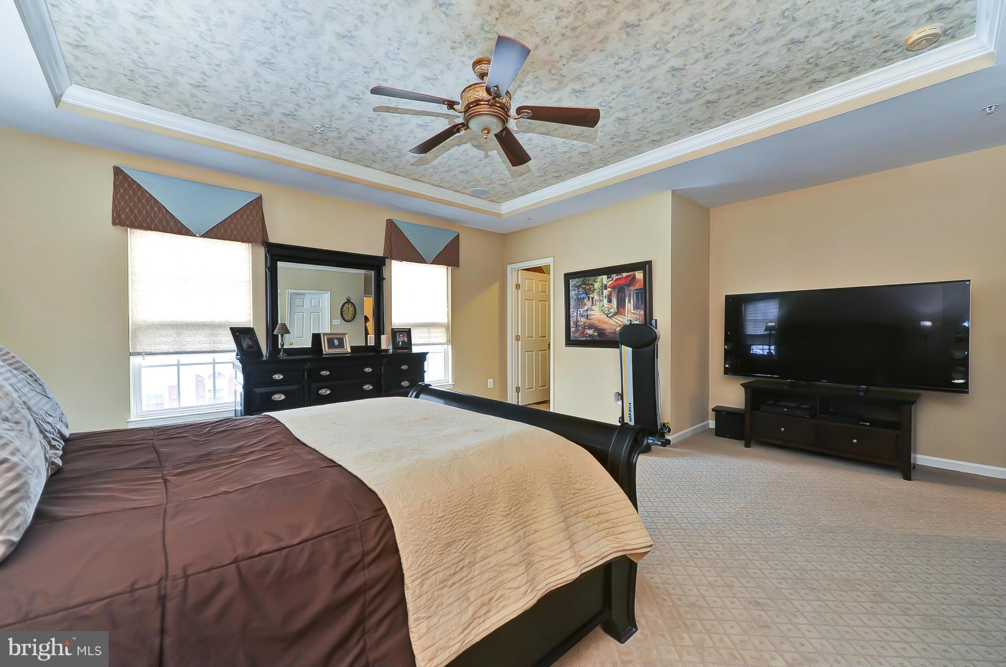 41888 Inspiration Terrace Aldie, VA 20105 - Photo 22 of 30 a bedroom with a bed and a flat screen tv