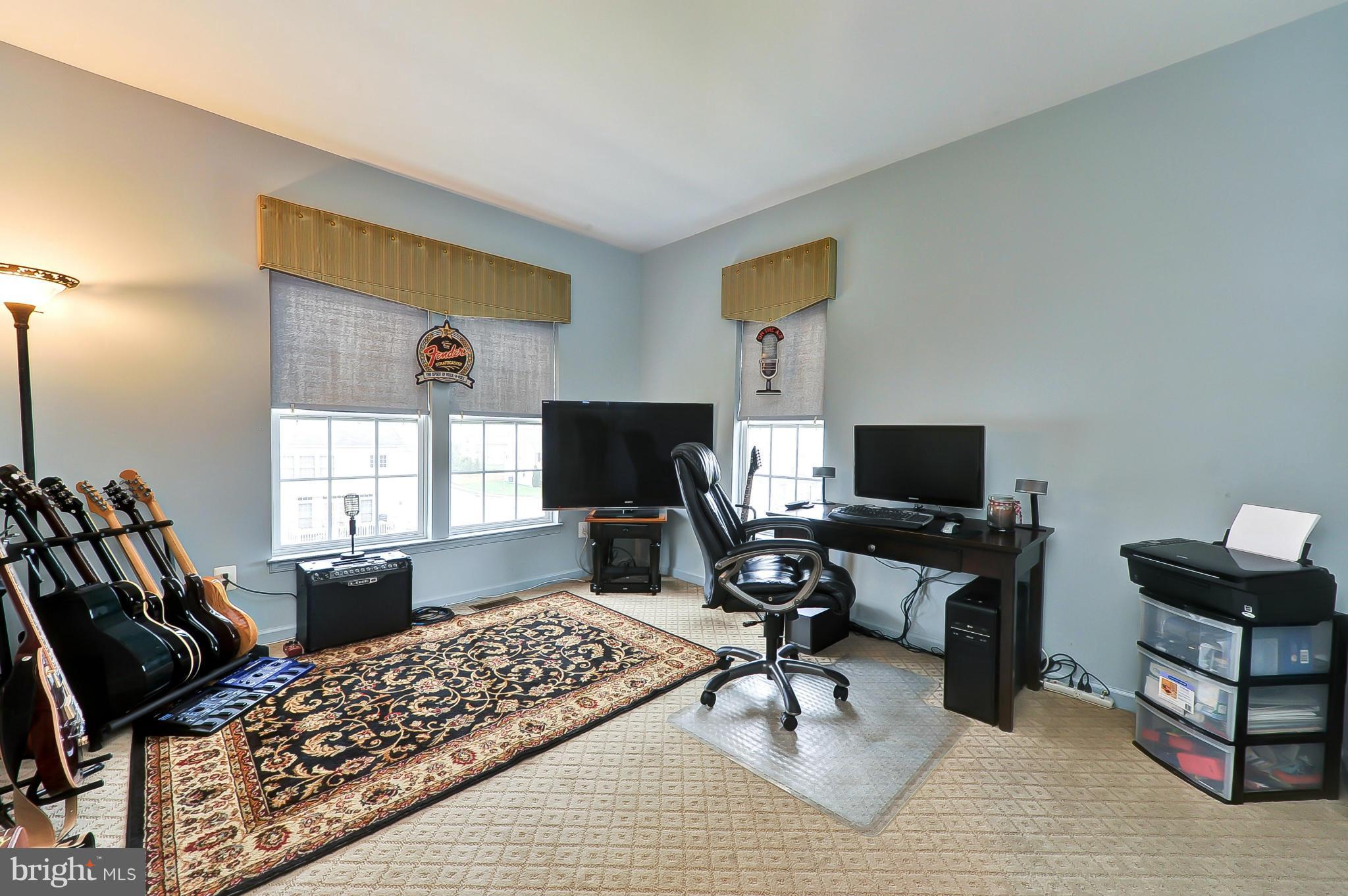 41888 Inspiration Terrace Aldie, VA 20105 - Photo 28 of 30 a living room with furniture a flat screen tv and a window