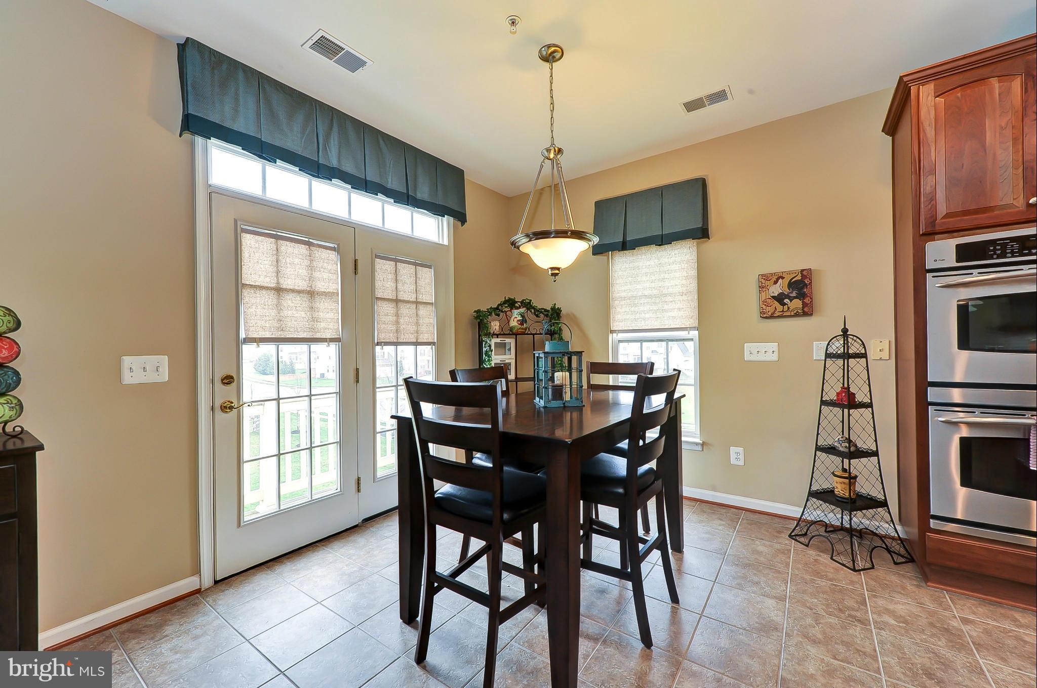 41888 Inspiration Terrace Aldie, VA 20105 - Photo 8 of 30 a view of a dining room with furniture window and wooden floor