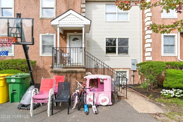 a view of a patio with a table and chairs and potted plants