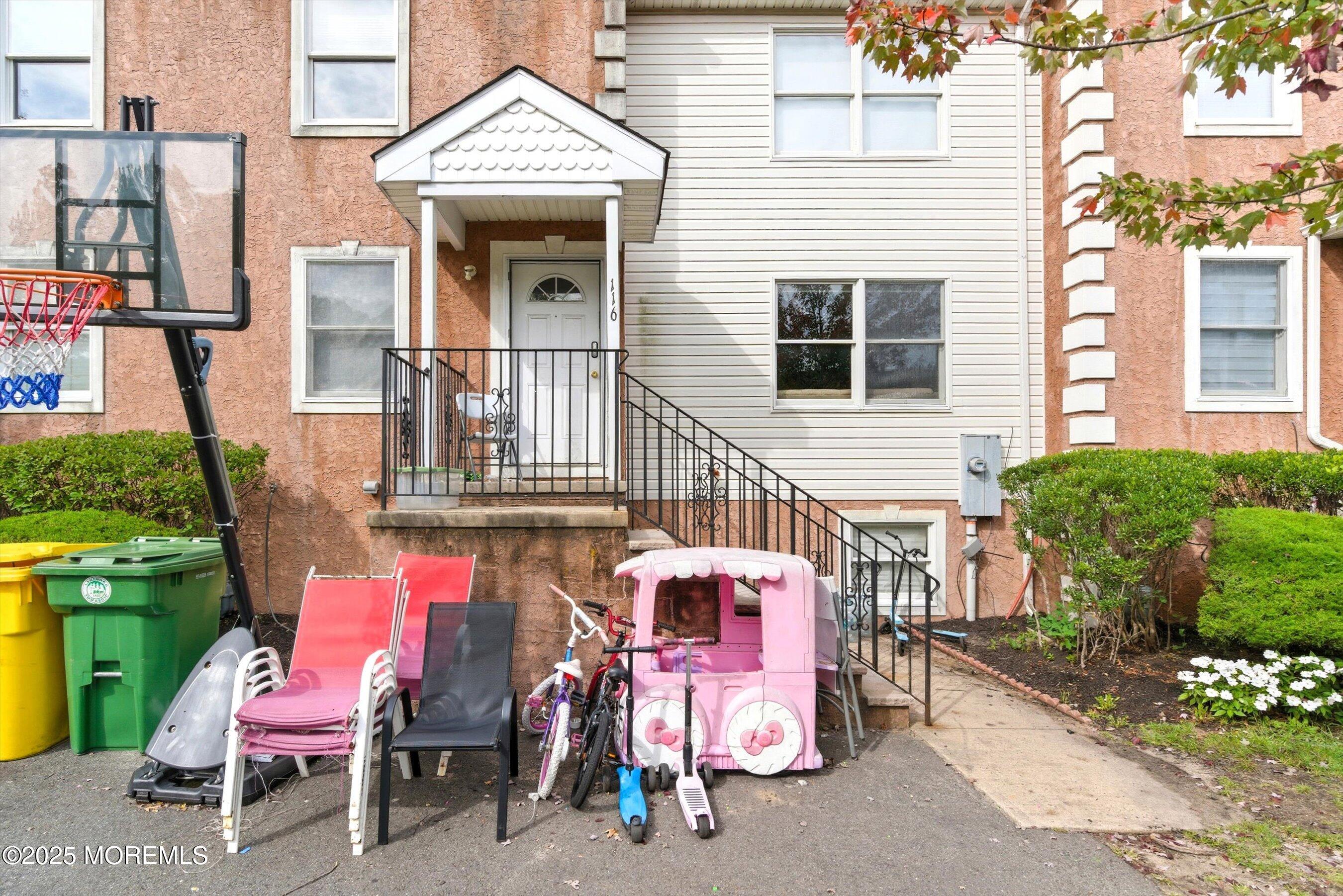 116 Ricky Lane Lakewood, NJ 08701 - Photo 3 of 9 a view of a patio with a table and chairs and potted plants