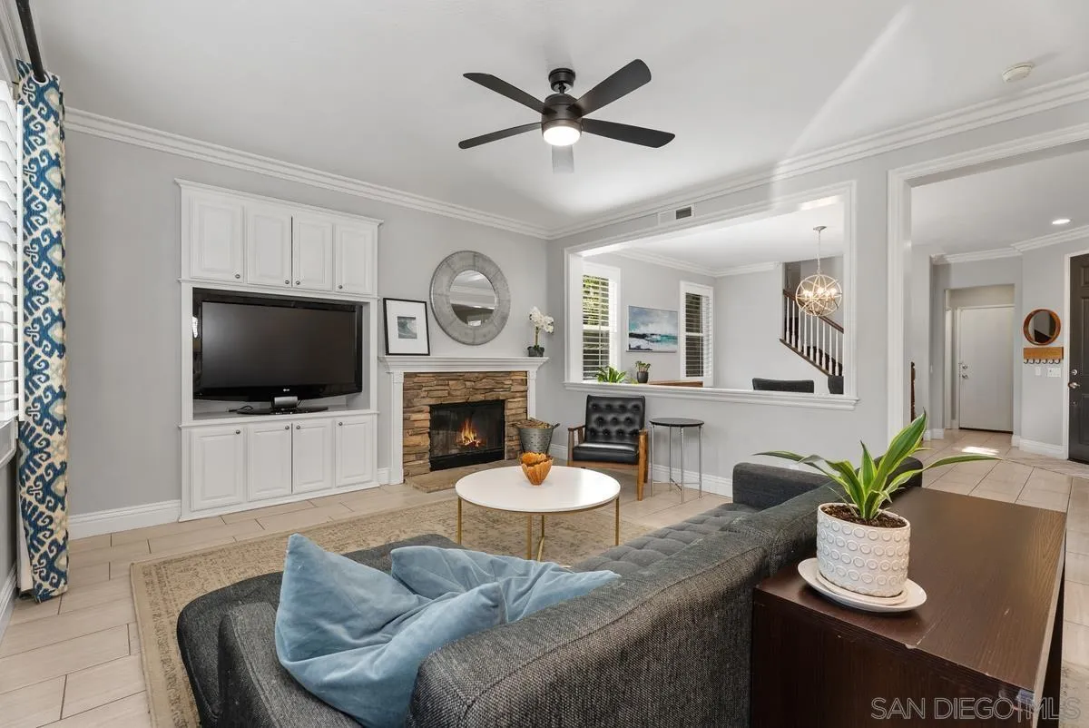 a living room with furniture a flat screen tv and a fireplace