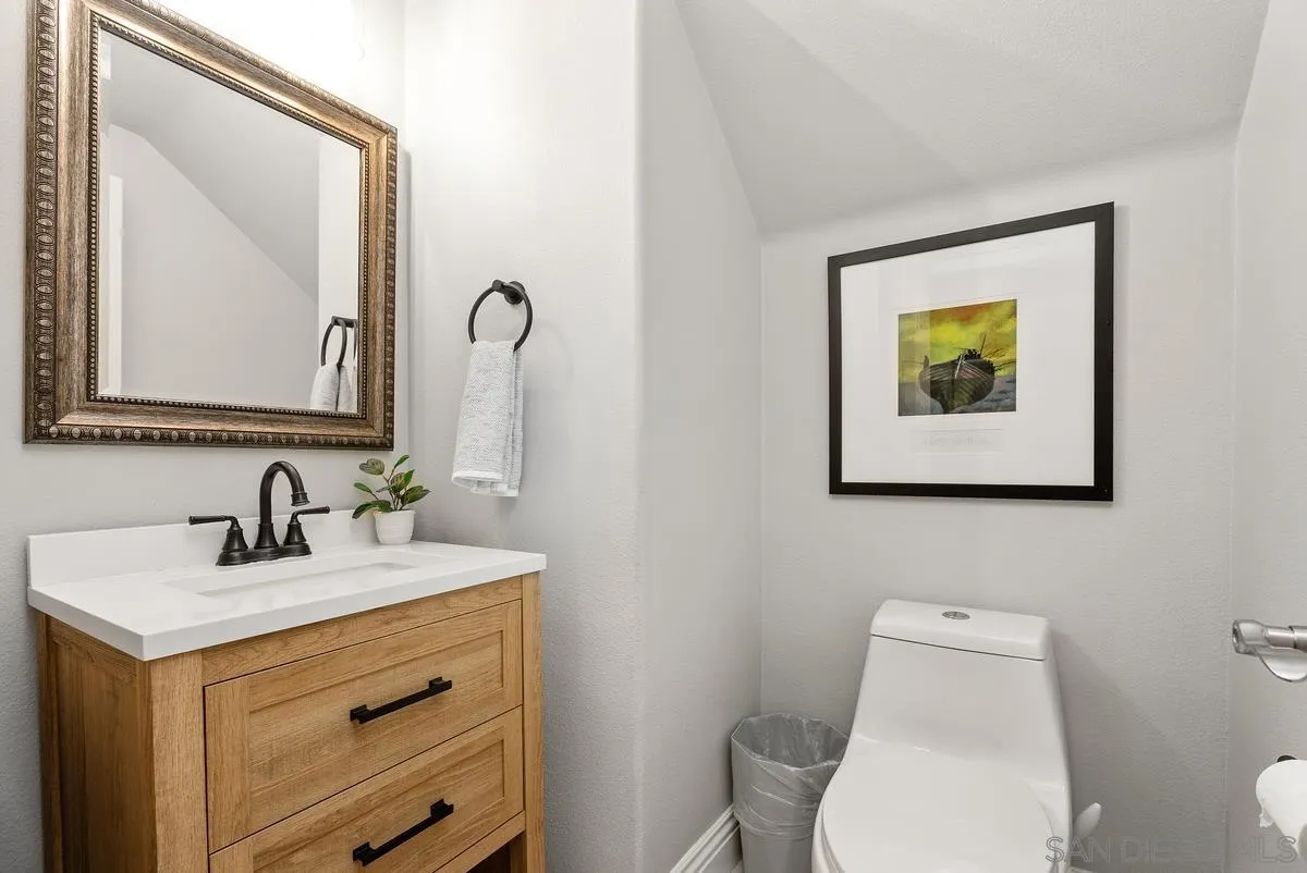 6 Reston Way Ladera Ranch, CA 92694 - Photo 11 of 39 a bathroom with a toilet sink vanity and mirror