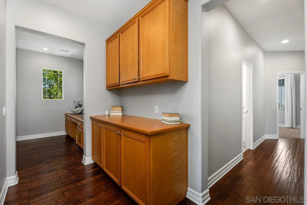 6 Reston Way Ladera Ranch, CA 92694 - Photo 13 of 39 a kitchen with stainless steel appliances granite countertop a refrigerator a sink dishwasher and wooden cabinets with wooden floor