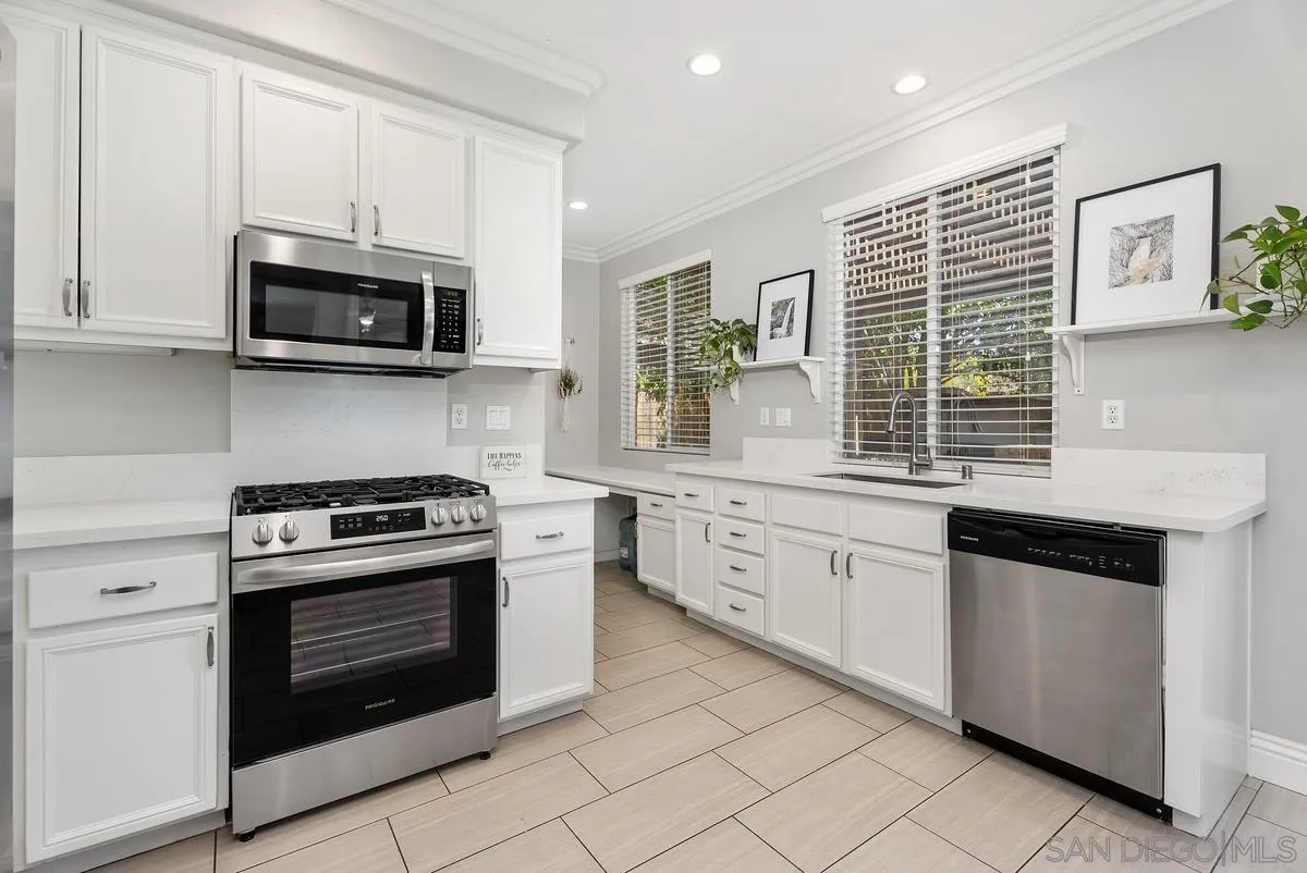 6 Reston Way Ladera Ranch, CA 92694 - Photo 9 of 39 a kitchen with stainless steel appliances granite countertop white cabinets a sink a stove and a microwave
