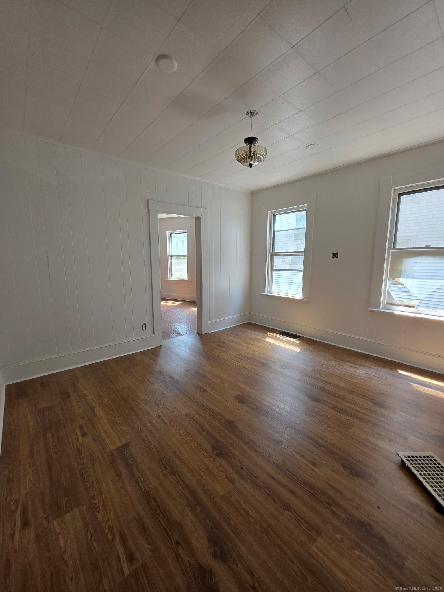 269 North Main Street Ansonia, CT 06401 - Photo 1 of 1 an empty room with wooden floor and windows