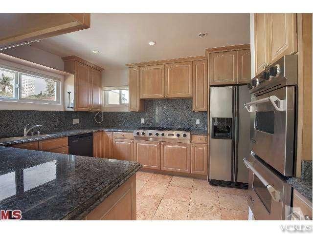 10386 Rochester Avenue Los Angeles, CA 90024 - Photo 11 of 18 a kitchen with granite countertop a sink stove and refrigerator