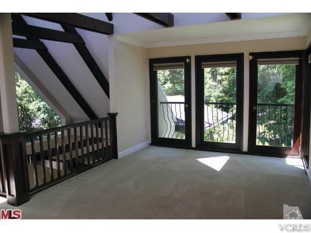 10386 Rochester Avenue Los Angeles, CA 90024 - Photo 12 of 18 a view of empty room with wooden floor and fan
