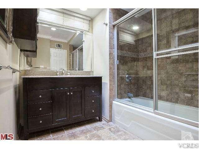 10386 Rochester Avenue Los Angeles, CA 90024 - Photo 17 of 18 a bathroom with a sink and a mirror