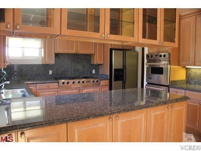10386 Rochester Avenue Los Angeles, CA 90024 - Photo 10 of 18 a kitchen with stainless steel appliances granite countertop a sink and a granite counter tops