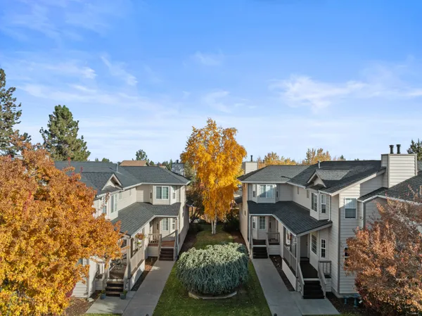 a front view of a residential apartment building with a yard