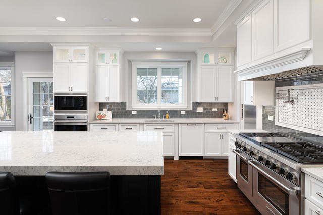 640 Wellner Road Naperville, IL 60540 - Photo 13 of 48 a kitchen with granite countertop a sink cabinets stainless steel appliances and a window