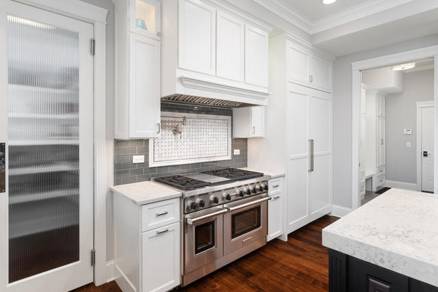 640 Wellner Road Naperville, IL 60540 - Photo 14 of 48 a kitchen with white cabinets and white appliances