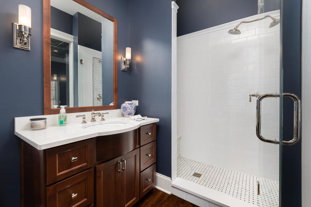 640 Wellner Road Naperville, IL 60540 - Photo 19 of 48 a bathroom with a sink a mirror and shower