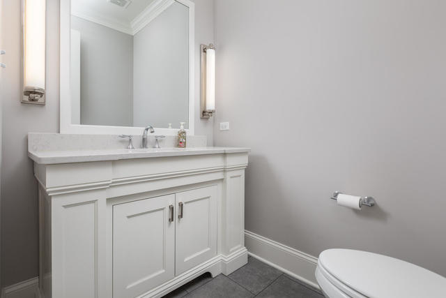 640 Wellner Road Naperville, IL 60540 - Photo 22 of 48 a bathroom with a sink vanity and a toilet