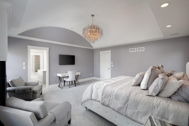 640 Wellner Road Naperville, IL 60540 - Photo 25 of 48 a bedroom with a bed and a couch