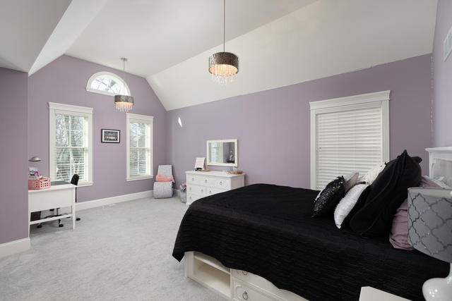 640 Wellner Road Naperville, IL 60540 - Photo 29 of 48 a bedroom with a bed and a chair