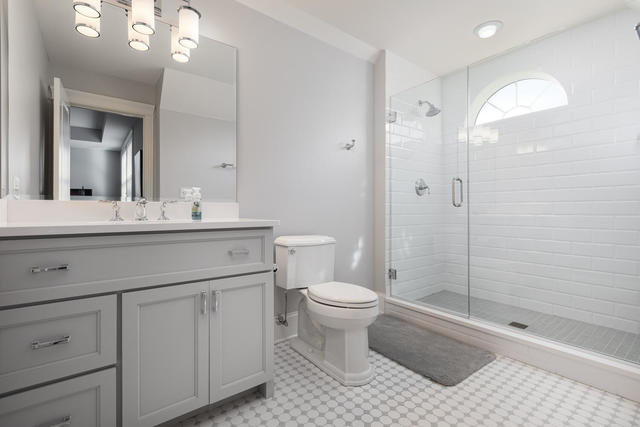 640 Wellner Road Naperville, IL 60540 - Photo 32 of 48 a bathroom with a sink a toilet and shower