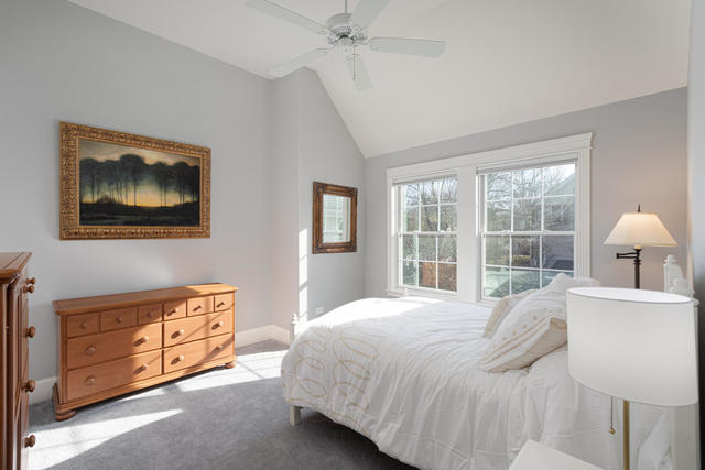 640 Wellner Road Naperville, IL 60540 - Photo 33 of 48 a bedroom with a bed and a lamp on dresser