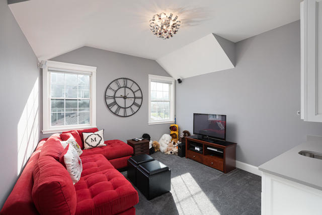 640 Wellner Road Naperville, IL 60540 - Photo 35 of 48 a living room with furniture a window and a flat screen tv
