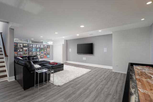 640 Wellner Road Naperville, IL 60540 - Photo 38 of 48 a living room with furniture and a flat screen tv