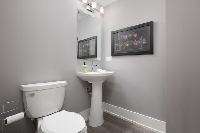 640 Wellner Road Naperville, IL 60540 - Photo 43 of 48 a bathroom with a toilet a sink and mirror