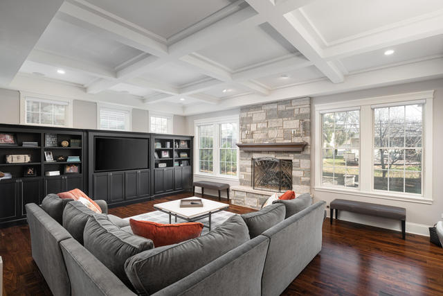 640 Wellner Road Naperville, IL 60540 - Photo 10 of 48 a living room with furniture a fireplace and a floor to ceiling window