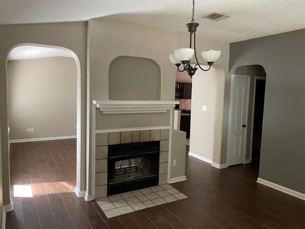 a living room with wooden floor a fireplace