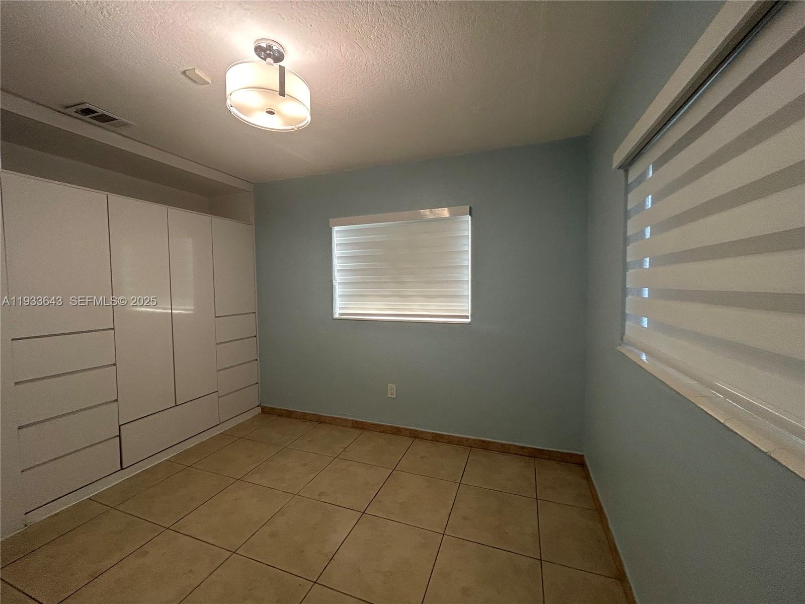 6202 Southwest 107th Avenue Miami, FL 33173 - Photo 13 of 22 a view of empty room with windows