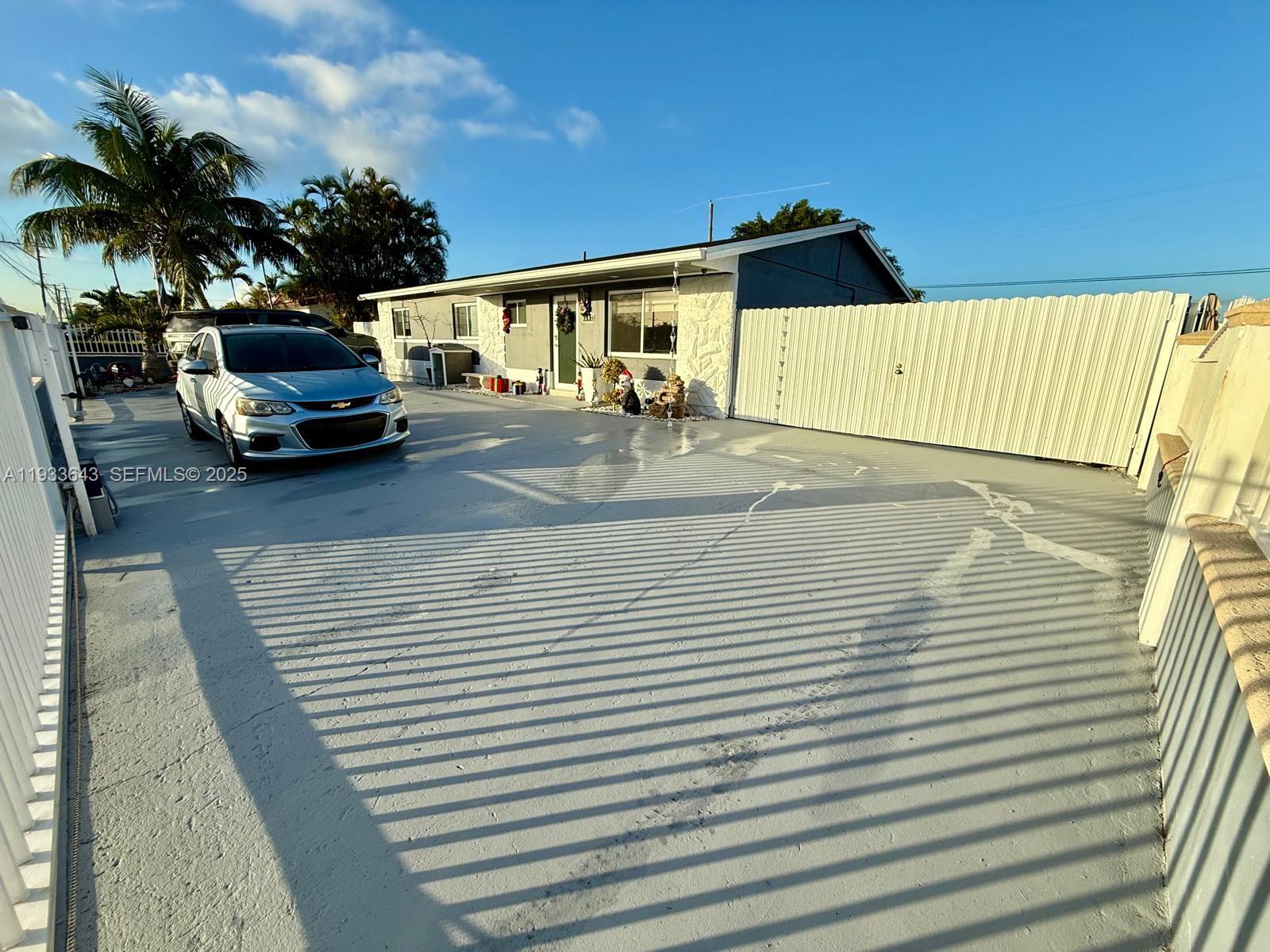6202 Southwest 107th Avenue Miami, FL 33173 - Photo 2 of 22 a view of a patio with table and chairs with wooden floor