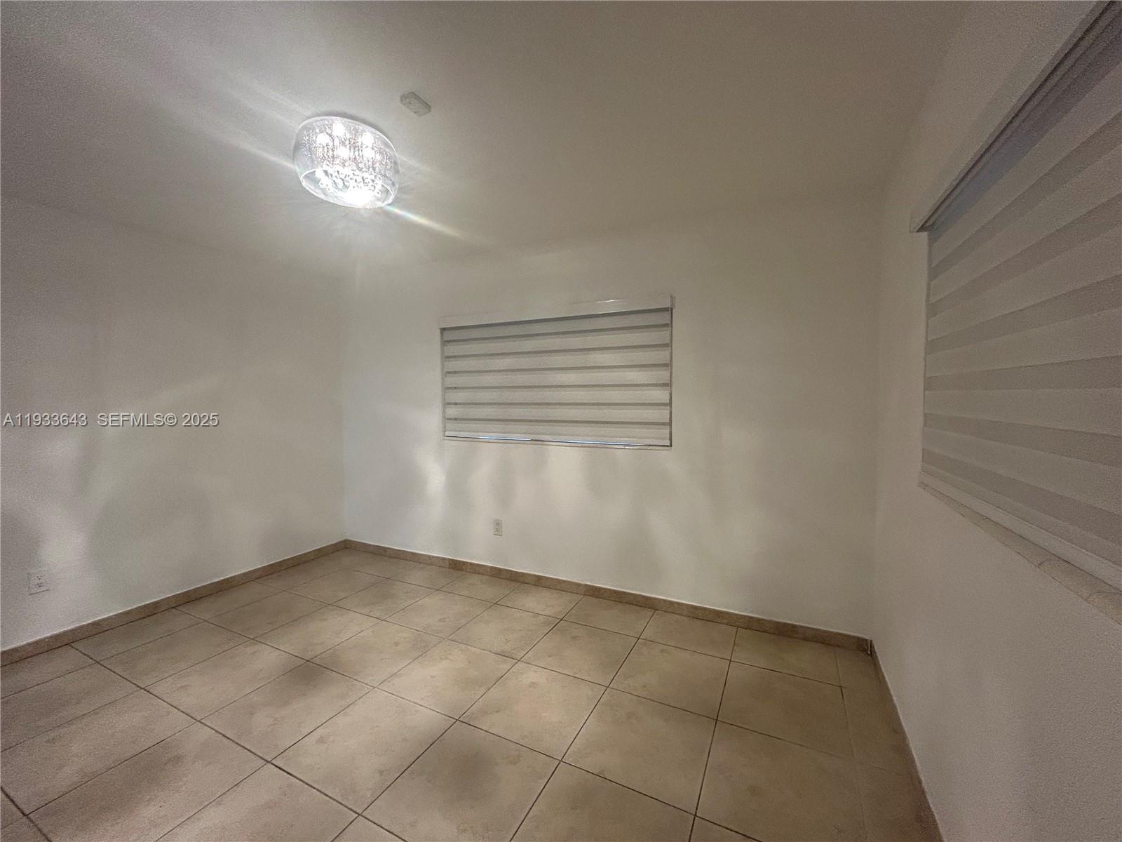 6202 Southwest 107th Avenue Miami, FL 33173 - Photo 10 of 22 a view of an empty room with a window
