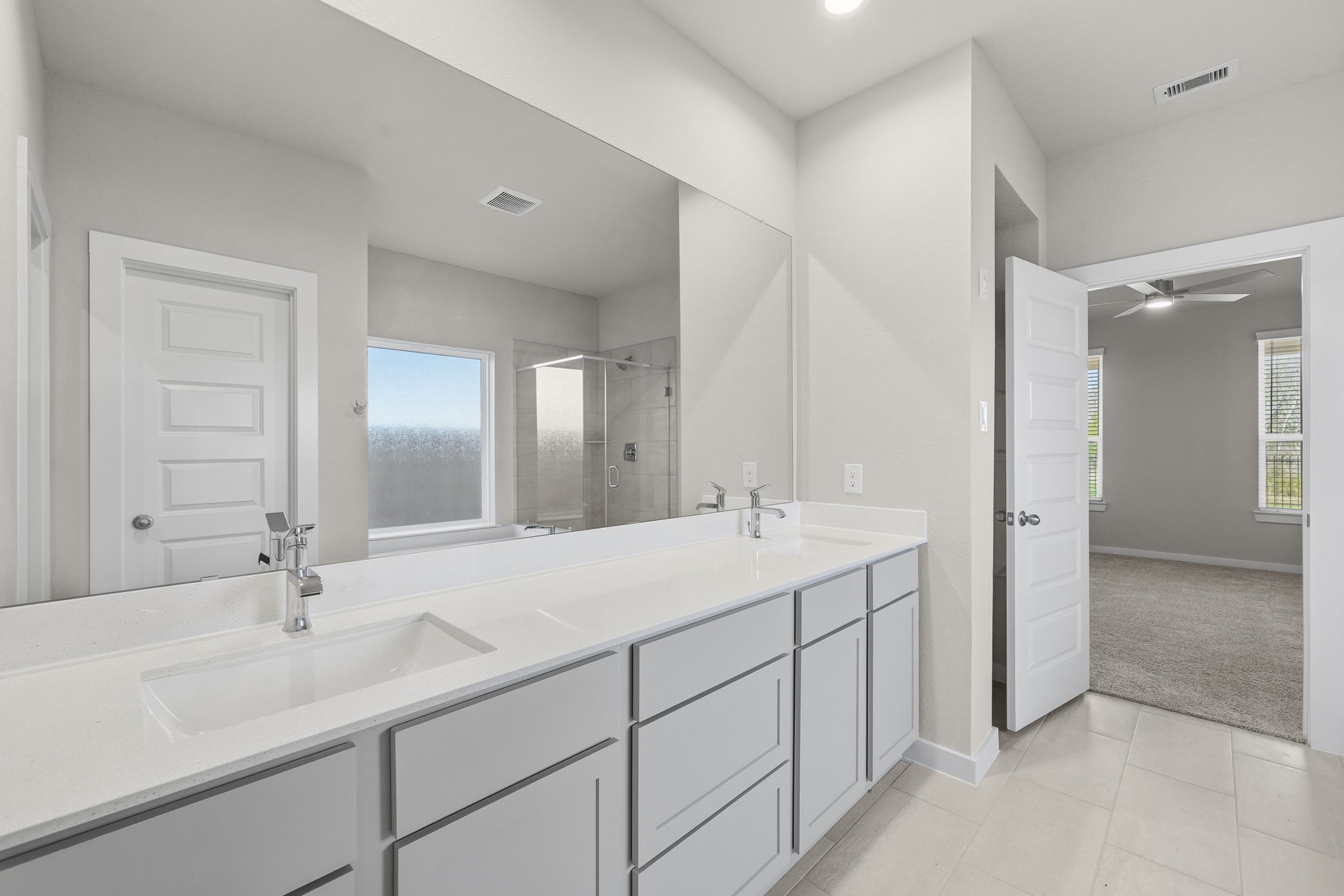 2571 Forest Cedar Lane Conroe, TX 77301 - Photo 18 of 42 a bathroom with a double vanity sink and mirror