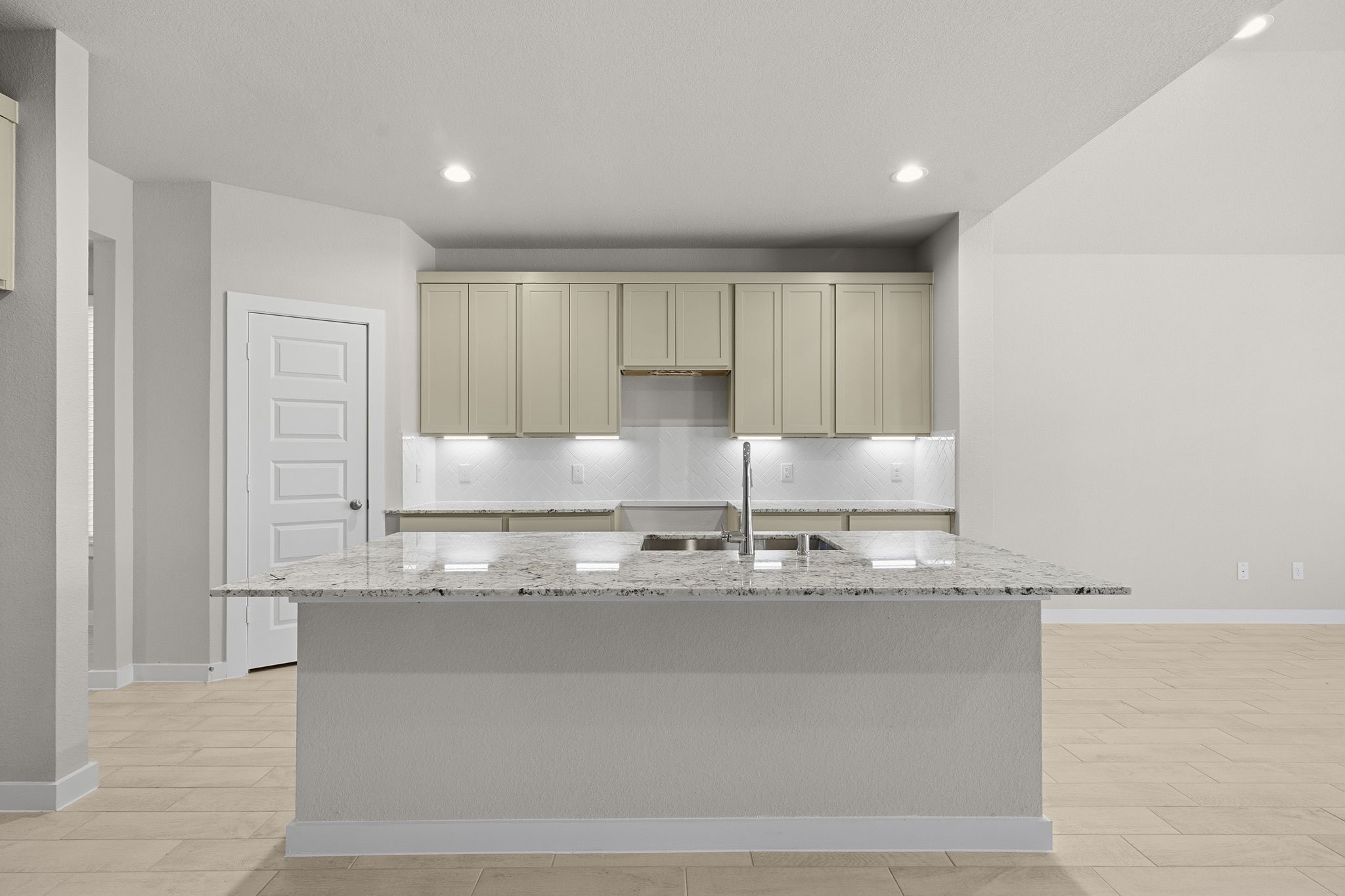 2571 Forest Cedar Lane Conroe, TX 77301 - Photo 2 of 42 a kitchen with granite countertop a sink and cabinets