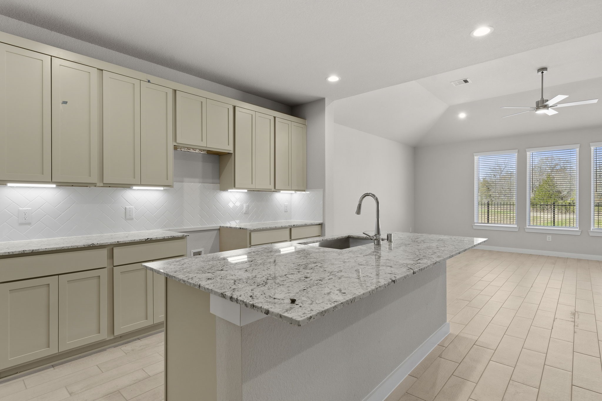 2571 Forest Cedar Lane Conroe, TX 77301 - Photo 3 of 42 a kitchen with granite countertop a sink and white cabinets