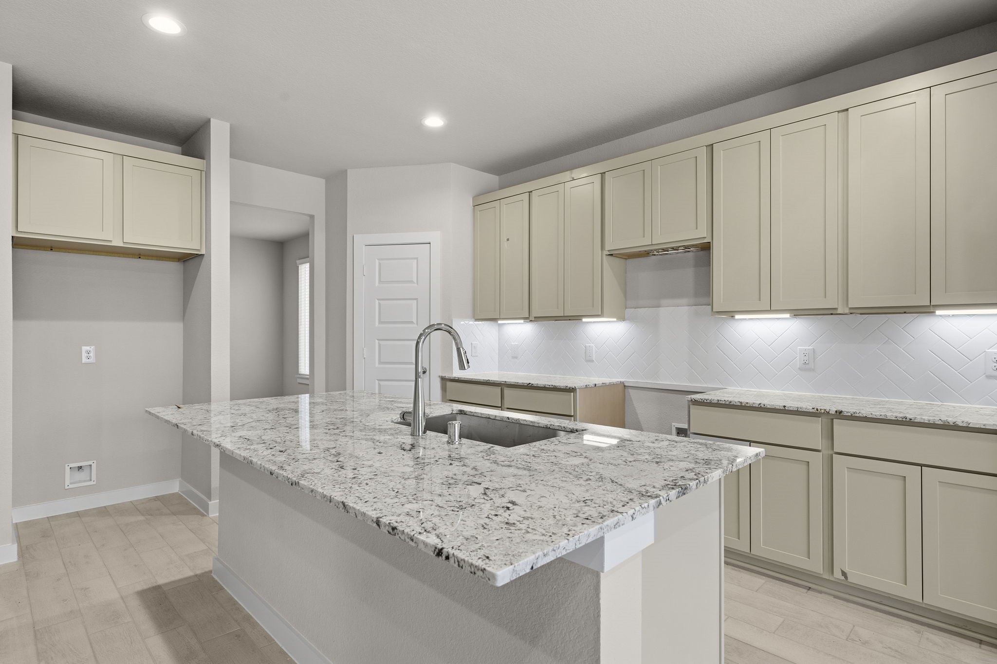 2571 Forest Cedar Lane Conroe, TX 77301 - Photo 6 of 42 a kitchen with granite countertop a sink a center island stainless steel appliances and cabinets