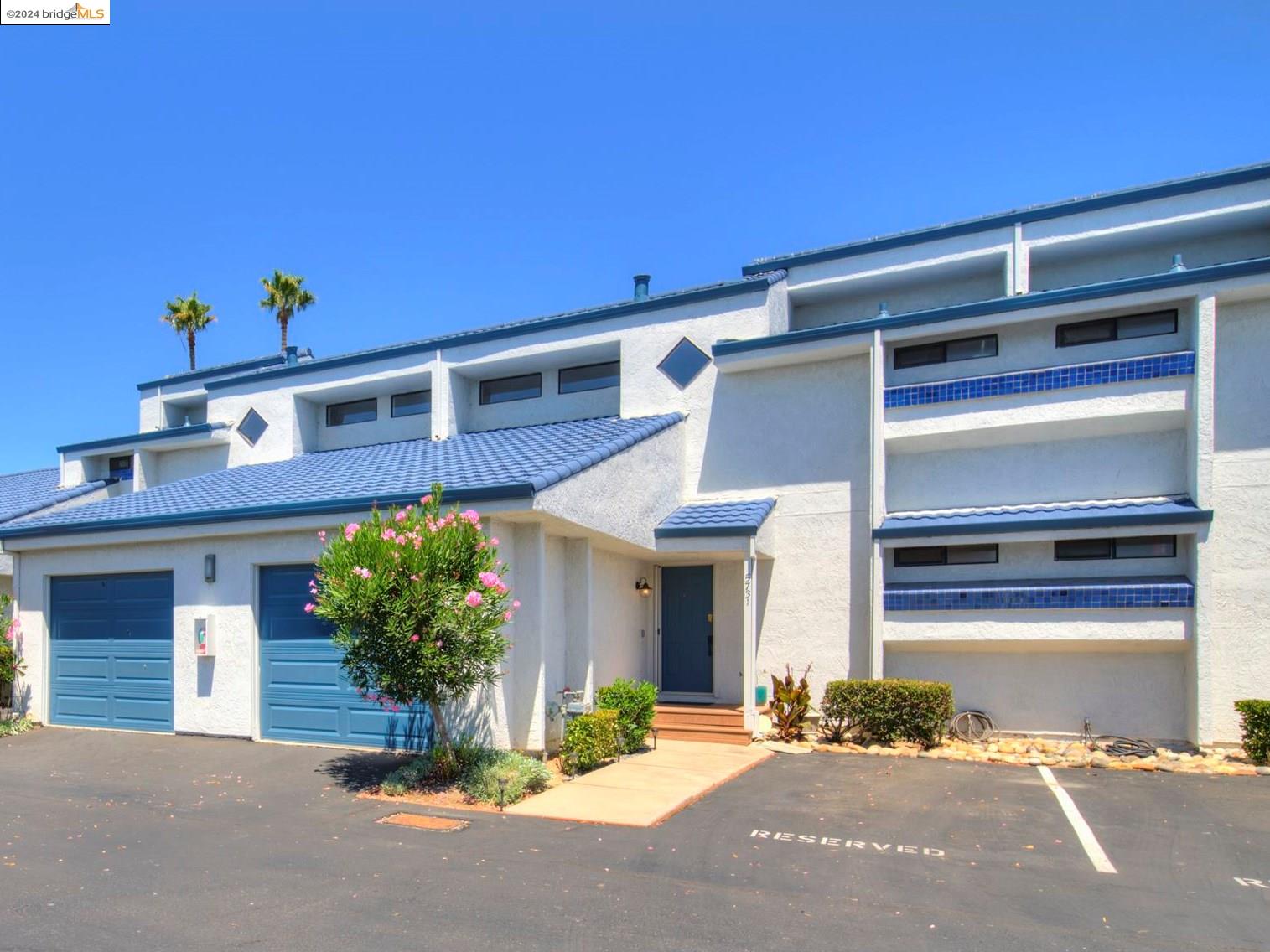 a front view of a house with a yard and a garage