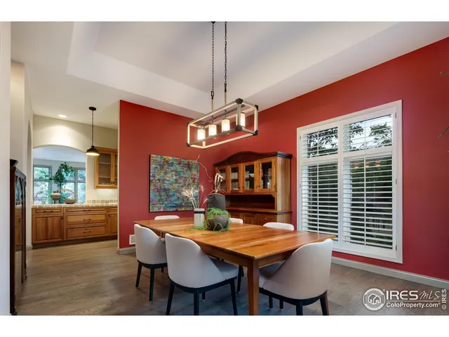 a dining room with furniture window and wooden floor