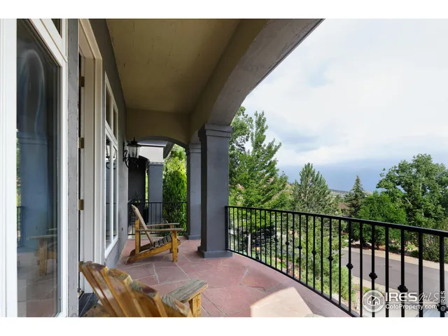 a view of a balcony with chair and table of the balcony