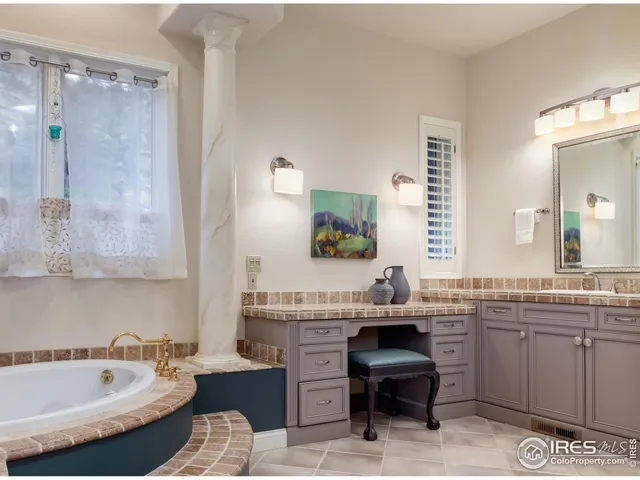 a bathroom with a tub sink and mirror