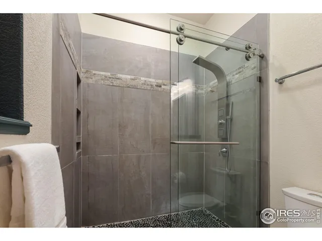 a bathroom with a shower and a sink