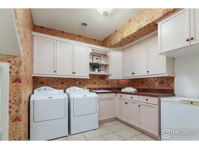 a kitchen with a sink dishwasher and white cabinets