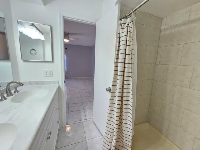 a bathroom with a double vanity sink and a mirror