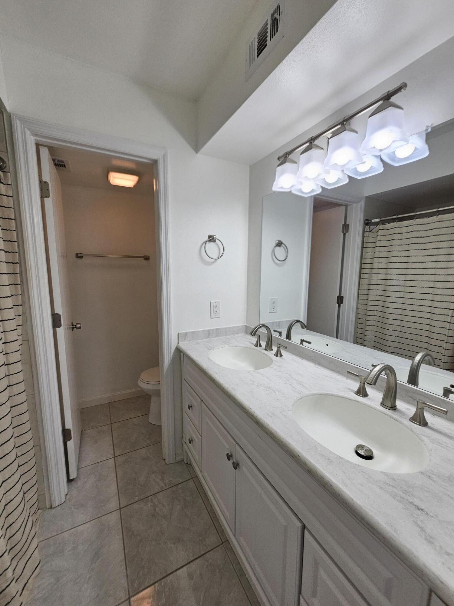 7330 N Highway, Unit 102 Cocoa, FL 32922 - Photo 17 of 26 a bathroom with a double vanity sink and a mirror