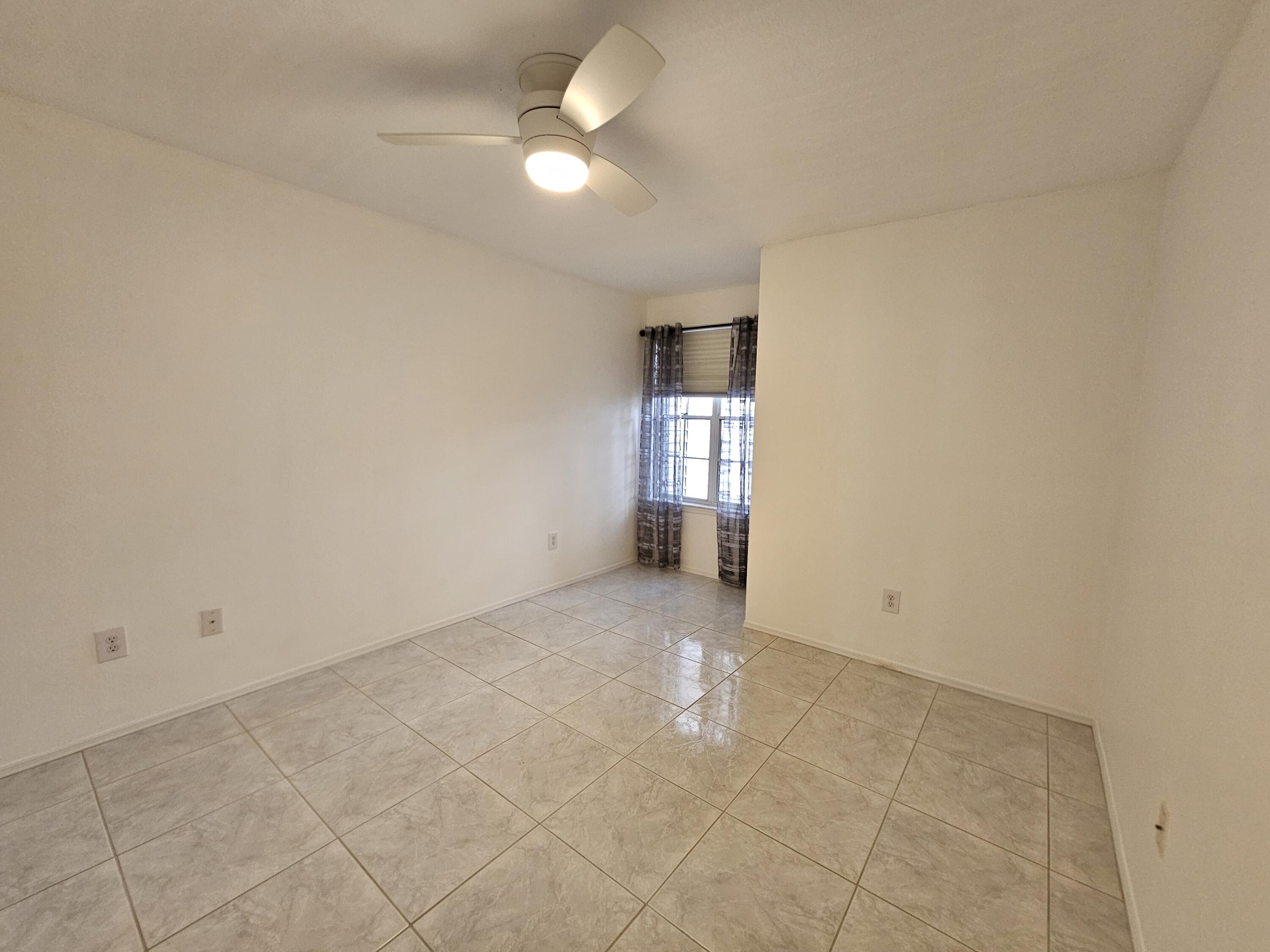7330 N Highway, Unit 102 Cocoa, FL 32922 - Photo 19 of 26 en empty room with windows and fan