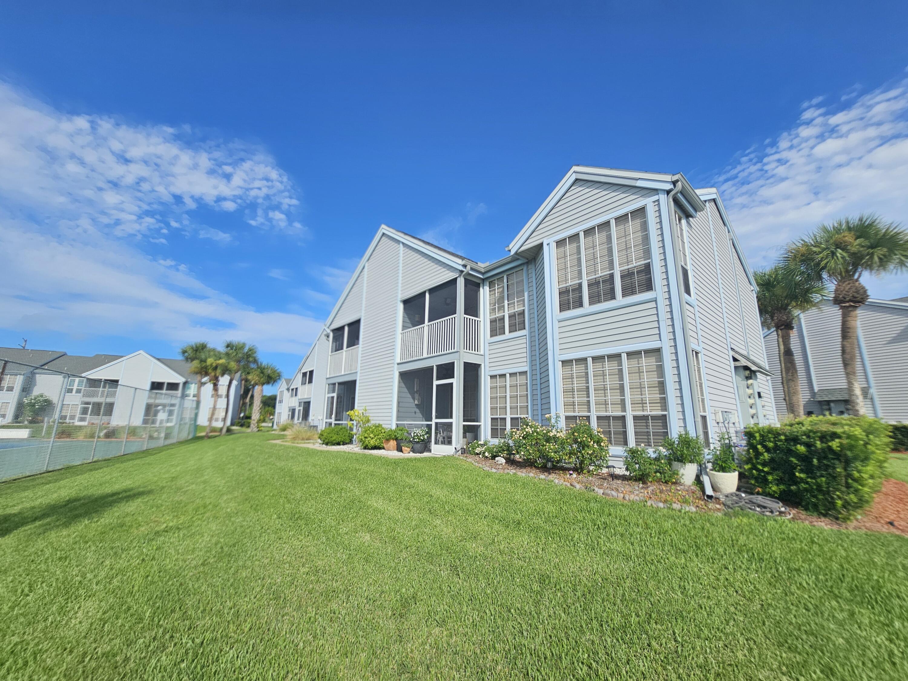 7330 N Highway, Unit 102 Cocoa, FL 32922 - Photo 24 of 26 a front view of a house with a garden
