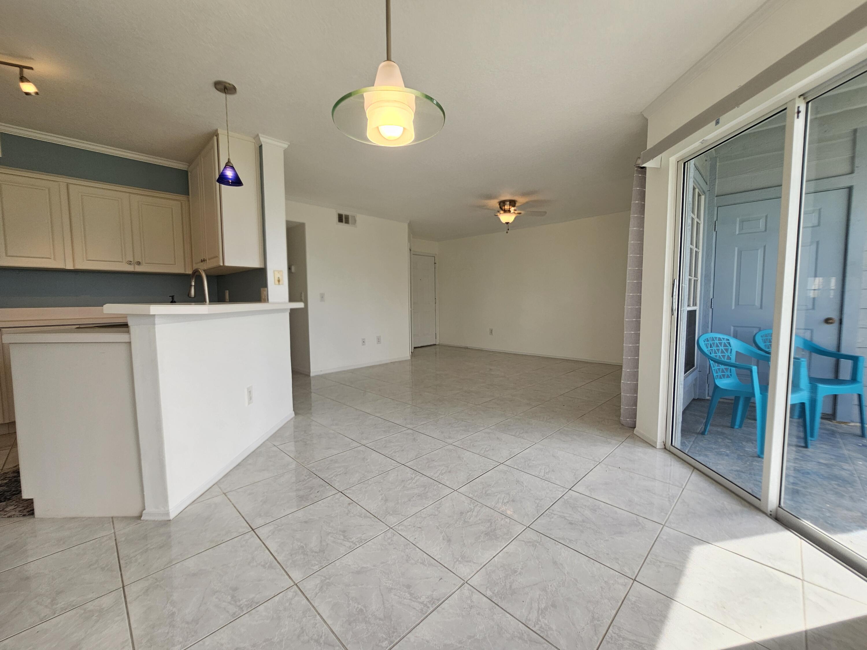 7330 N Highway, Unit 102 Cocoa, FL 32922 - Photo 6 of 26 wooden floor in an empty room and a kitchen