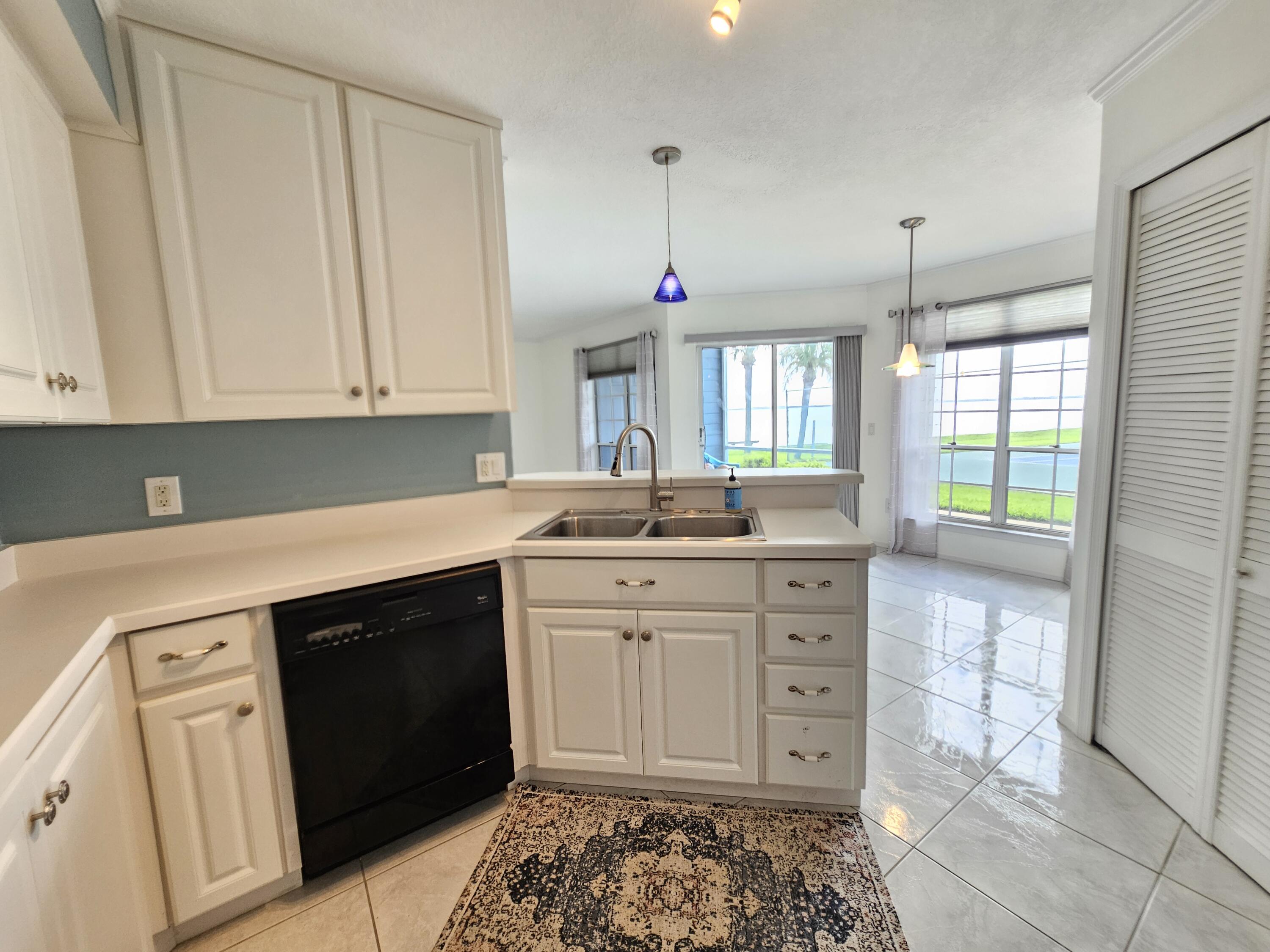7330 N Highway, Unit 102 Cocoa, FL 32922 - Photo 10 of 26 a kitchen with stainless steel appliances granite countertop a sink and cabinets
